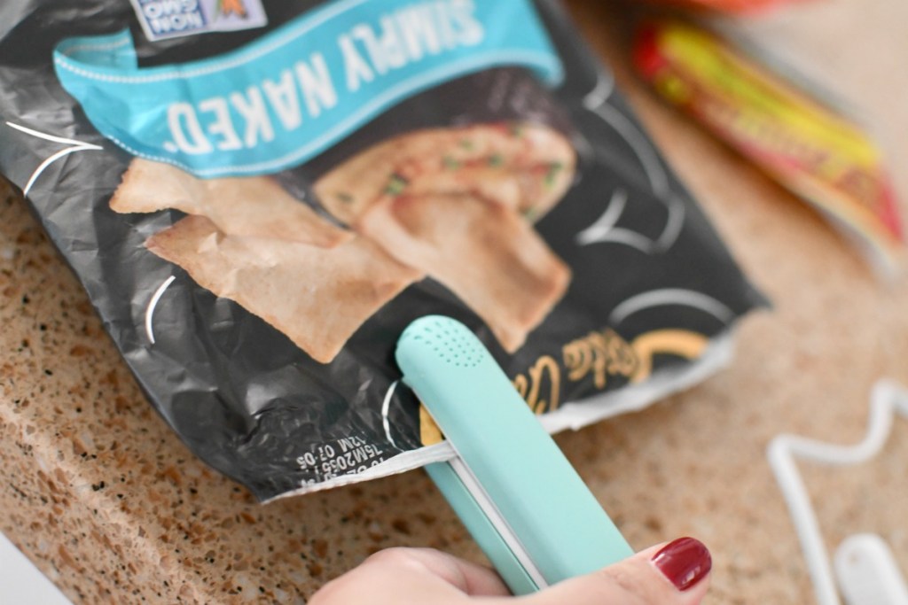 re-sealing a bag of chips using a handheld heat sealer 