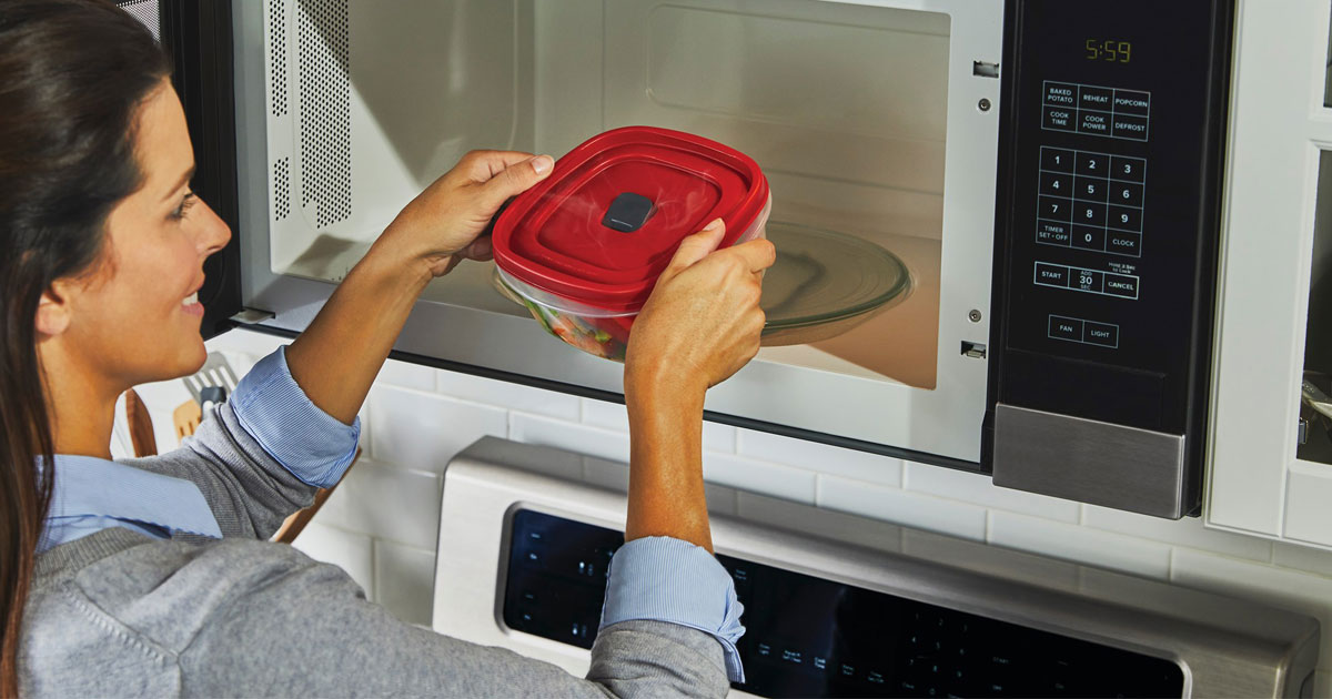 woman putting rubbermaid vented lid storage container into microwave