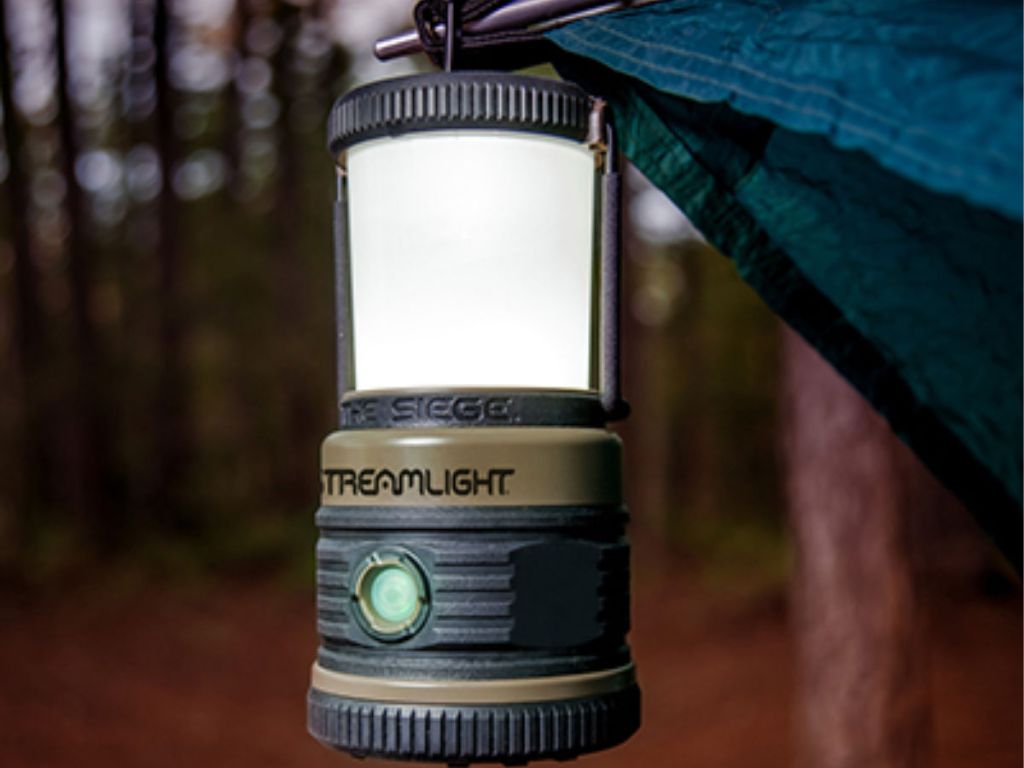 lantern hanging on tent in woods 