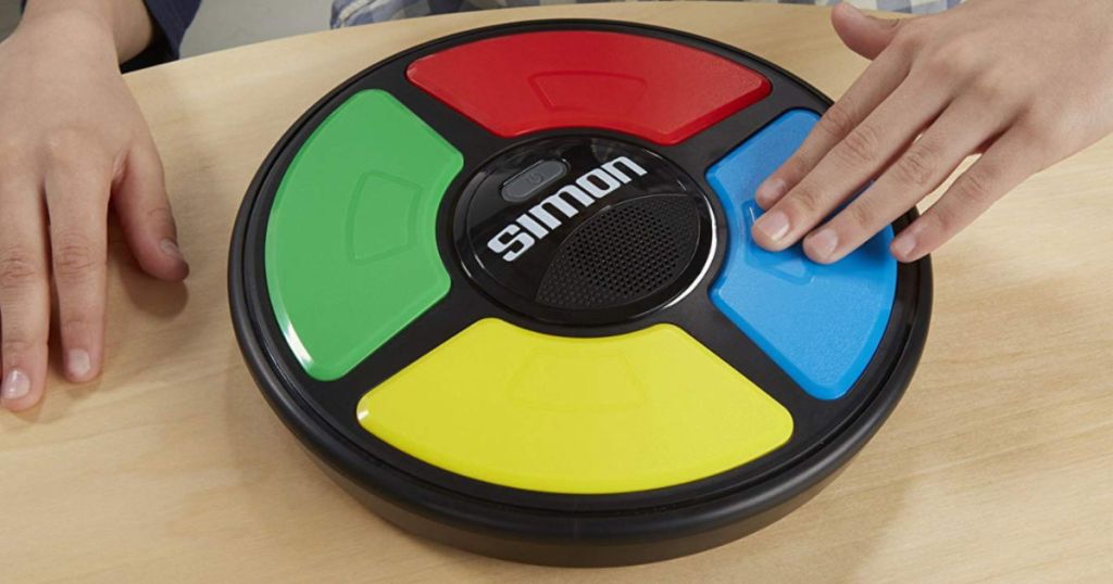 hand pressing the blue button on the simon game