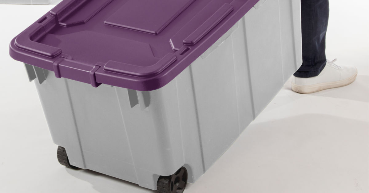 person pulling wheeled storage tote