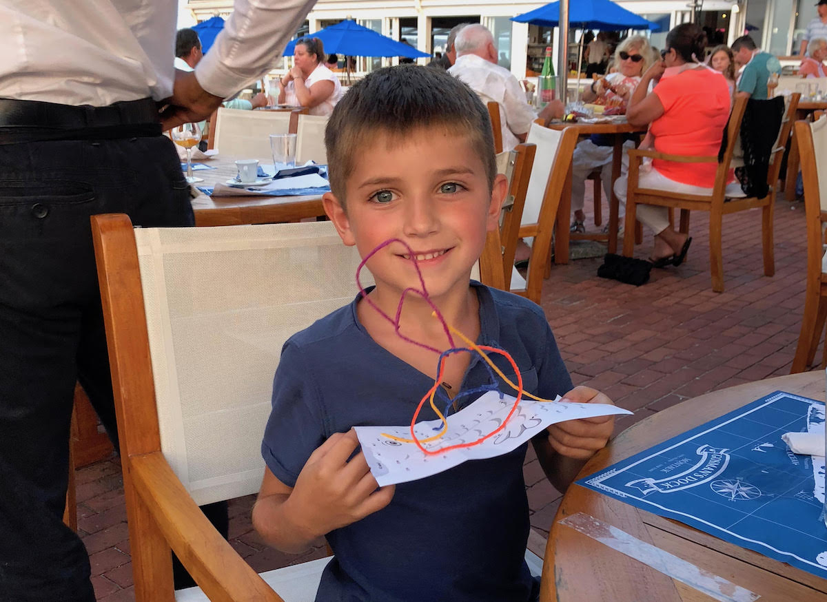 boy holding paper with wikkistix string