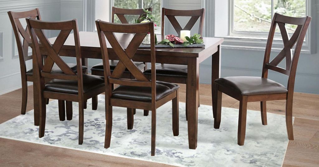 dining room table and 6 chairs all sitting on an area rug