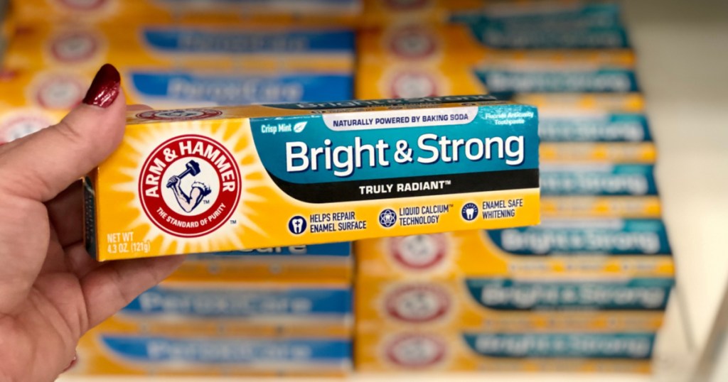 hand holding up box of arm & hammer toothpaste