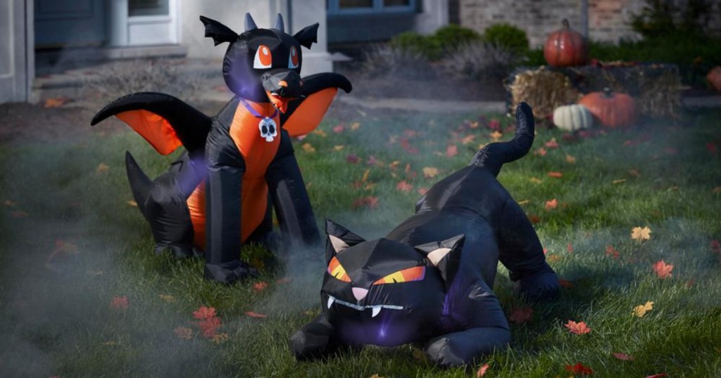 black cat and drag inflatables in yard