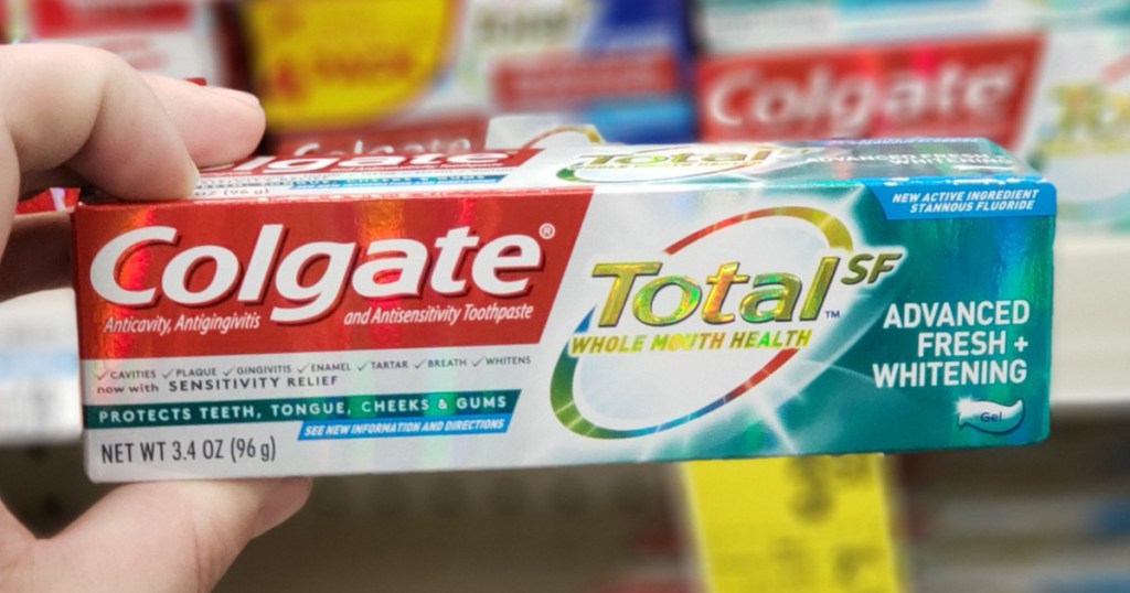 Hand holding Colgate TotalSF Toothpaste at CVS