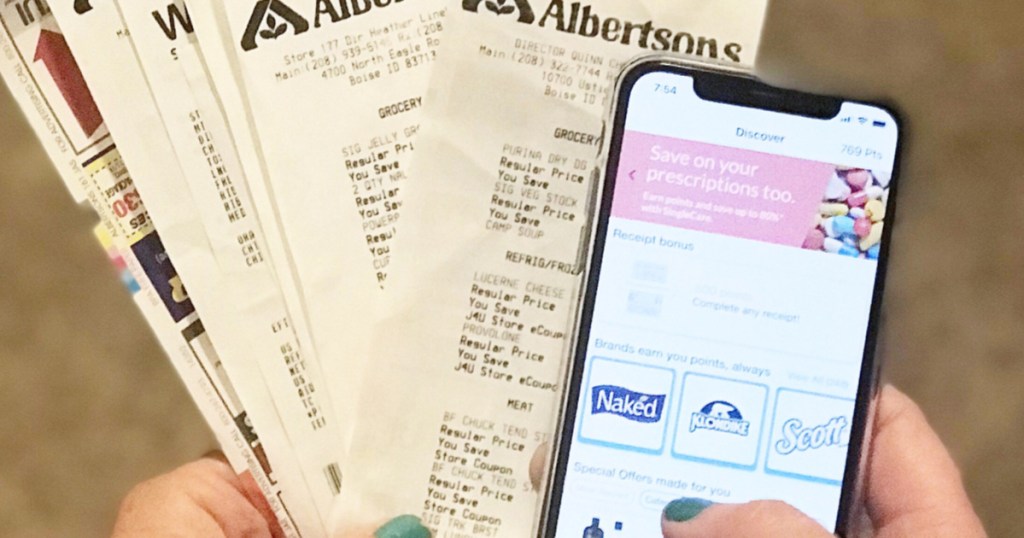 Woman holding receipts and smartphone Fetch Rewards