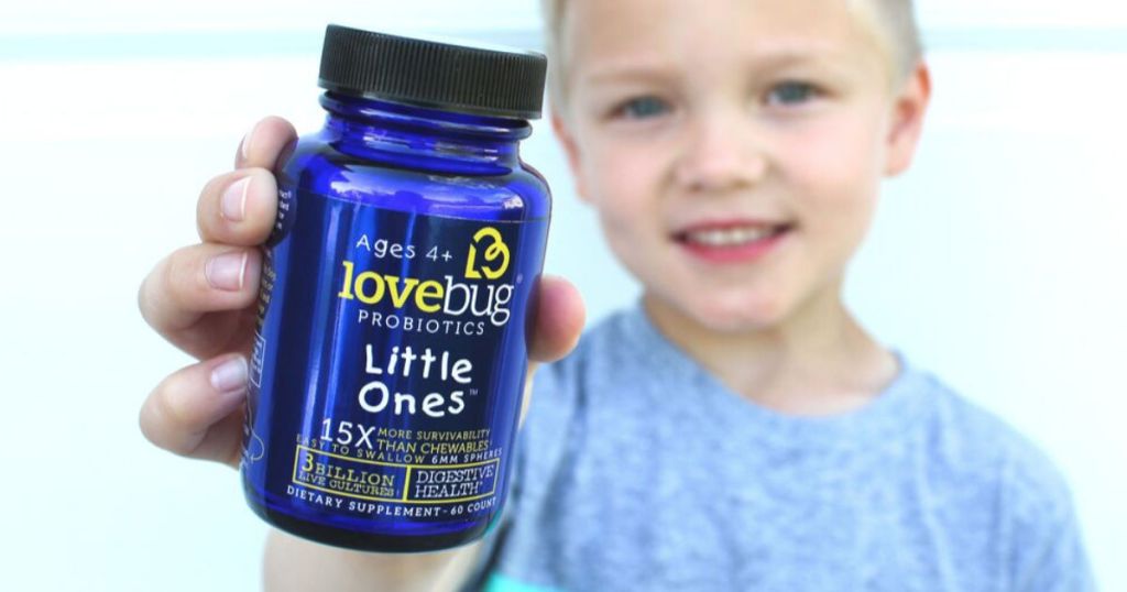 Little boy holding Kids Love Bugs Probiotics