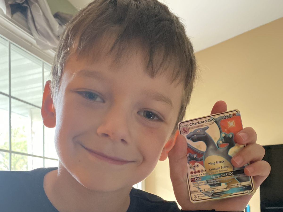Little Boy Holding Pokemon cards