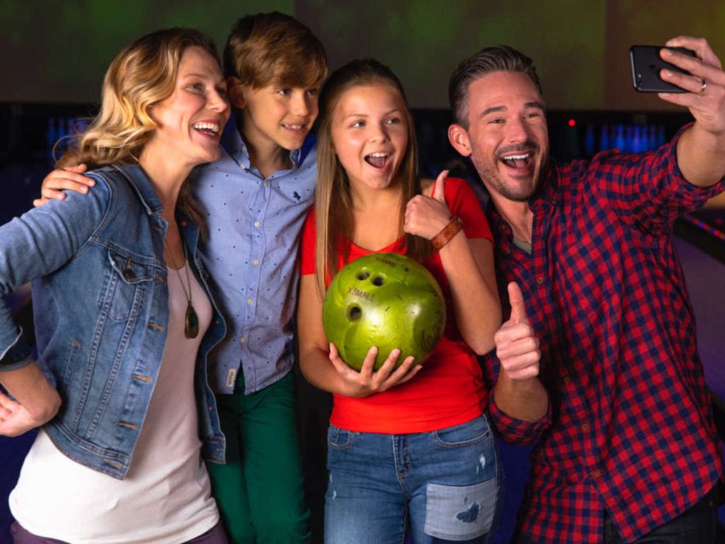 Family taking a selfie at a bowling alley