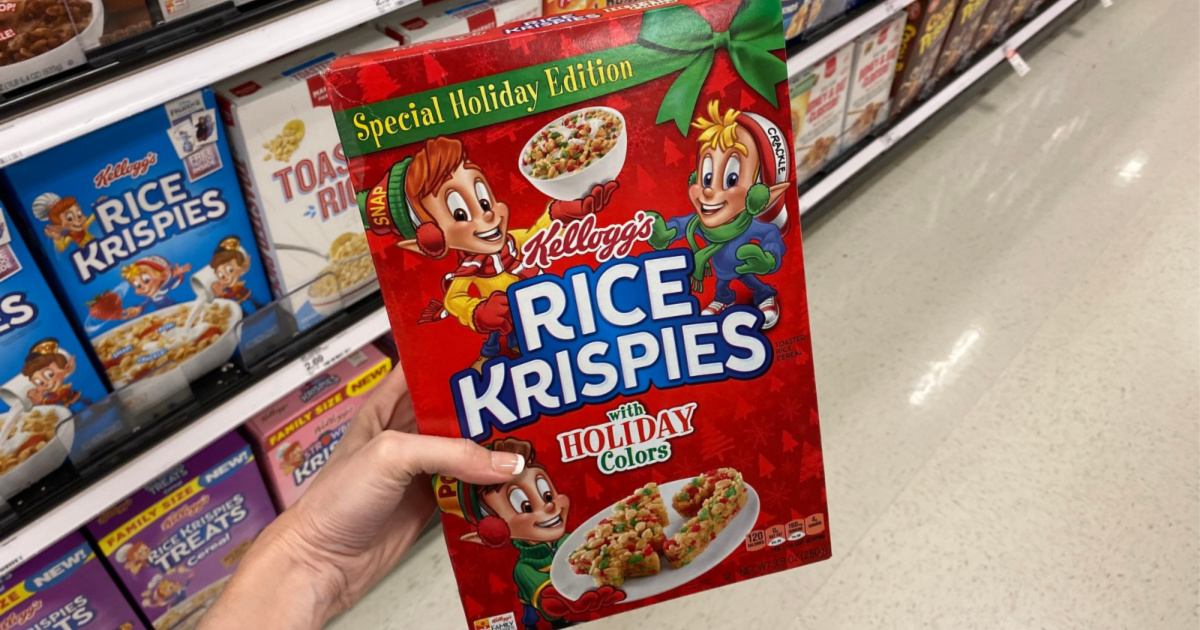hand holding up box of christmas rce krispies cereal