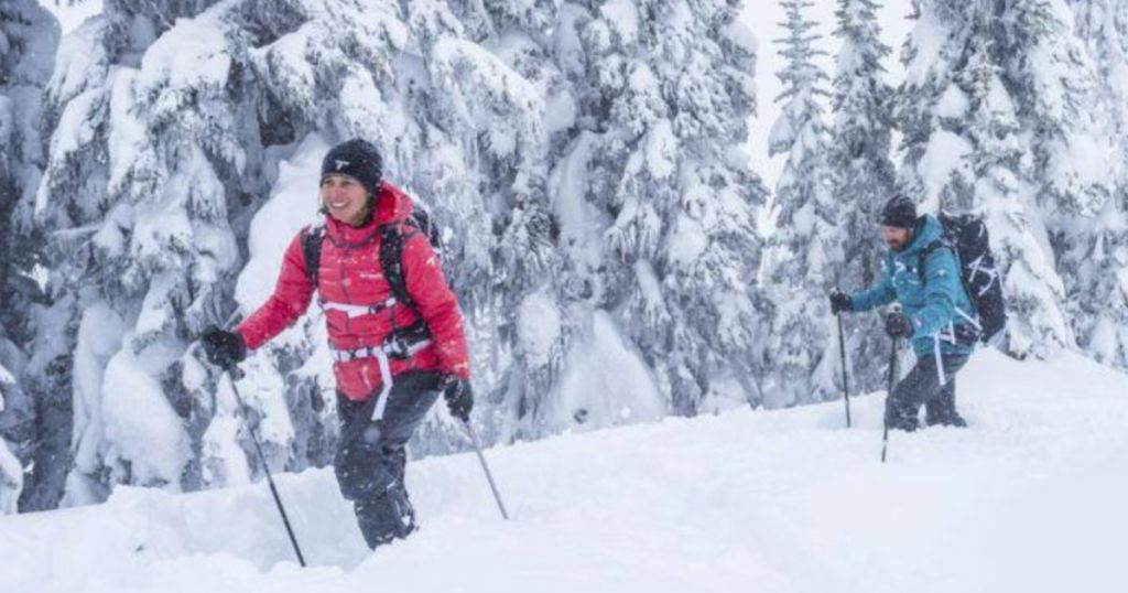 Woman and man skiing in the snow wearing columbia gear
