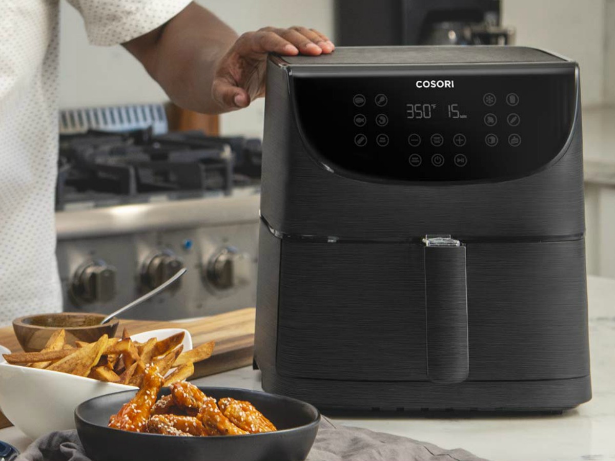 Amazon Corsori Air Fryer in black on counter in kitchen near air fried foods
