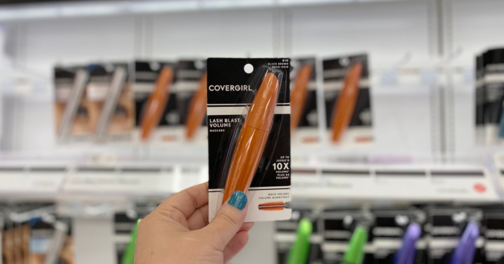 hand holding covergirl mascara in store with blurry background