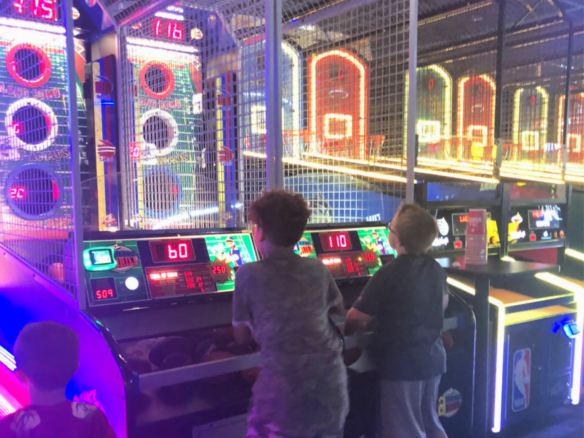 two kids using their free gameplay at Dave & Busters which is one of the birthday freebies on our list