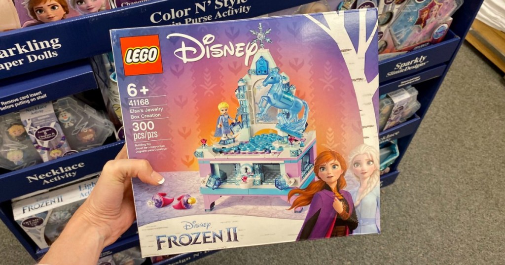 LEGO Frozen 2 set in hand in-store in front of LEGO display aisle