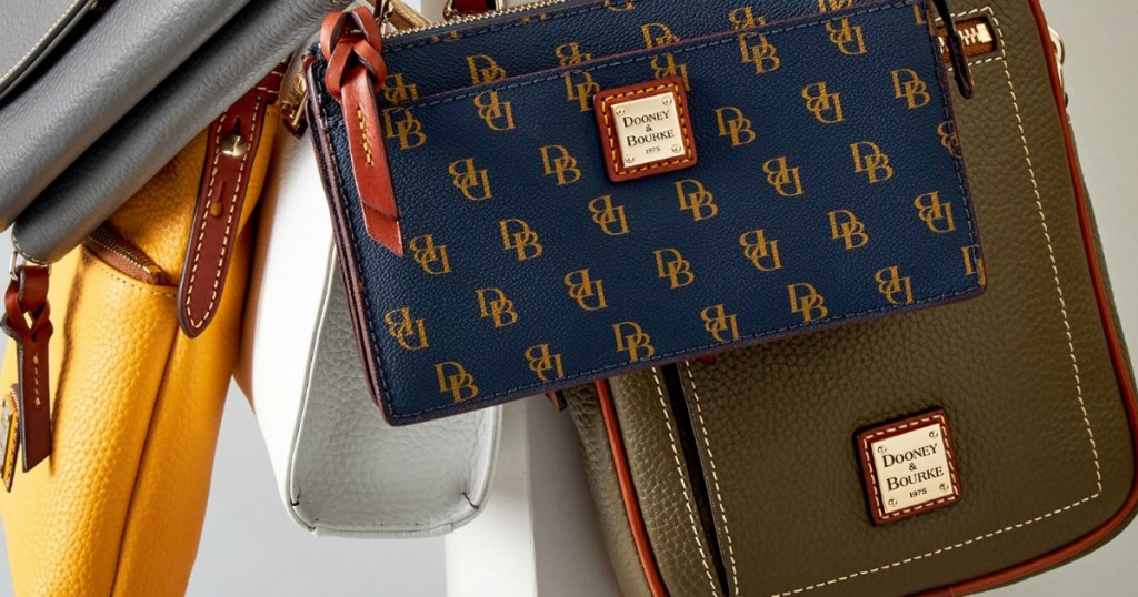 Dooney & Bourke Crossbody Bags in various styles and colors hanging up