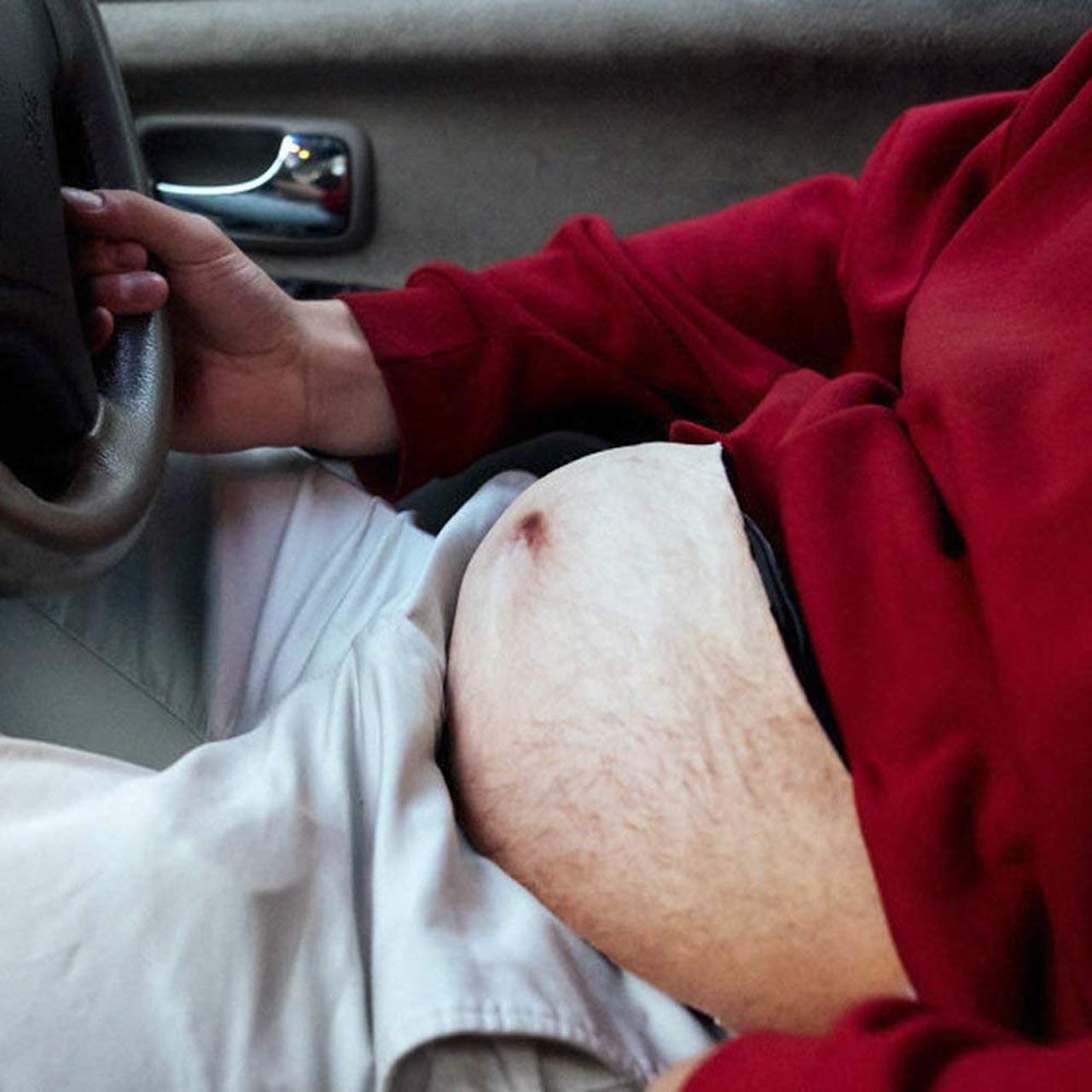 man driving in car with dad bod fanny pack