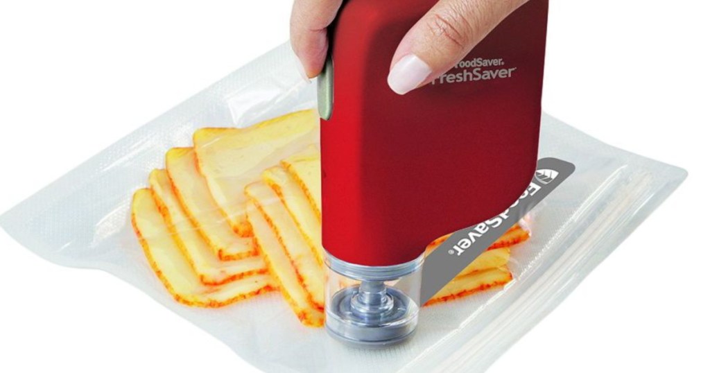 hand holding red food saver sealing system