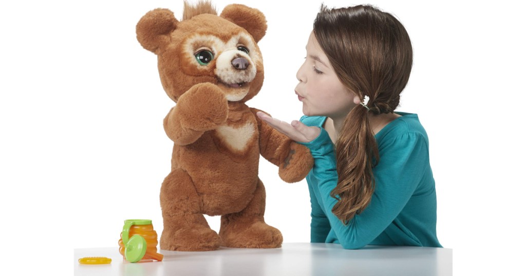 girl playing with furreal cubby the bear interactive plush toy