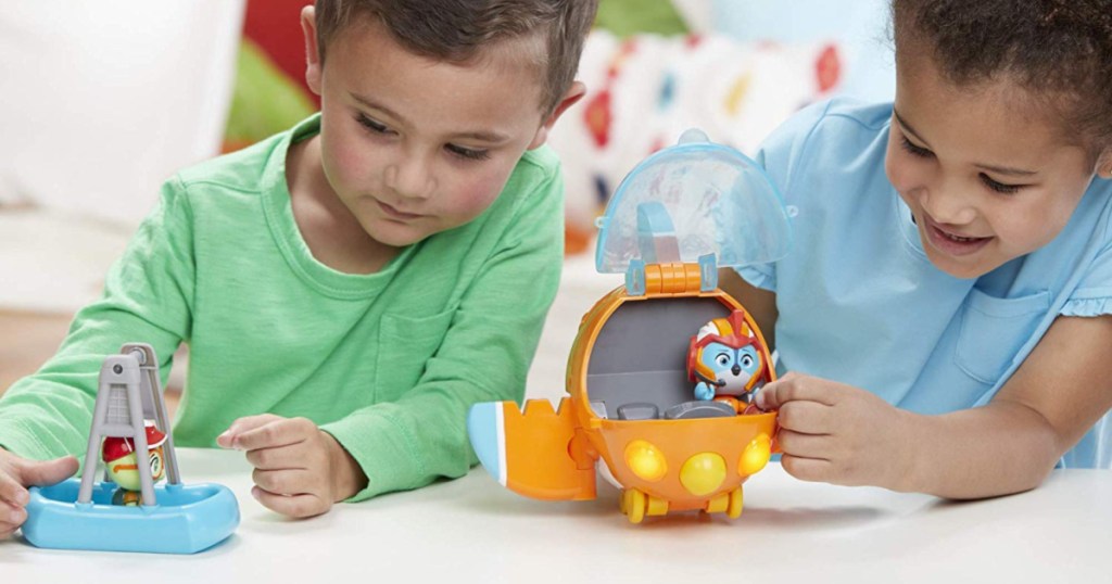 boy and girl playing with rescue vehicle set