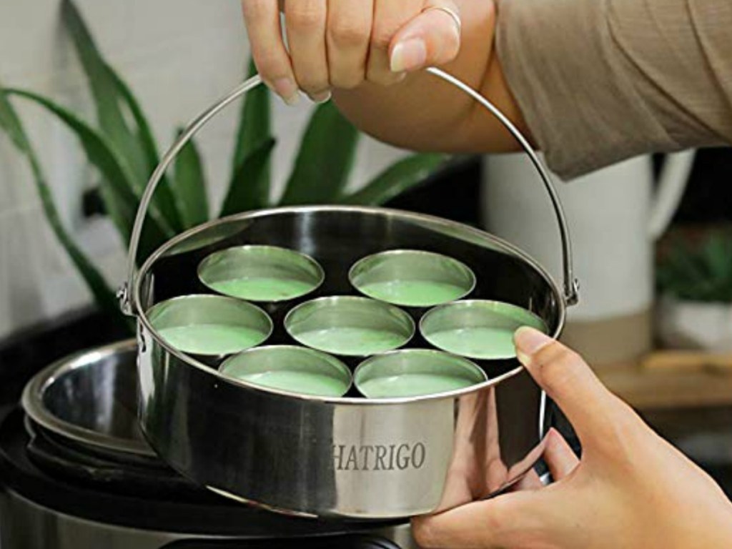 Woman placing egg bit cups into pressure cooker