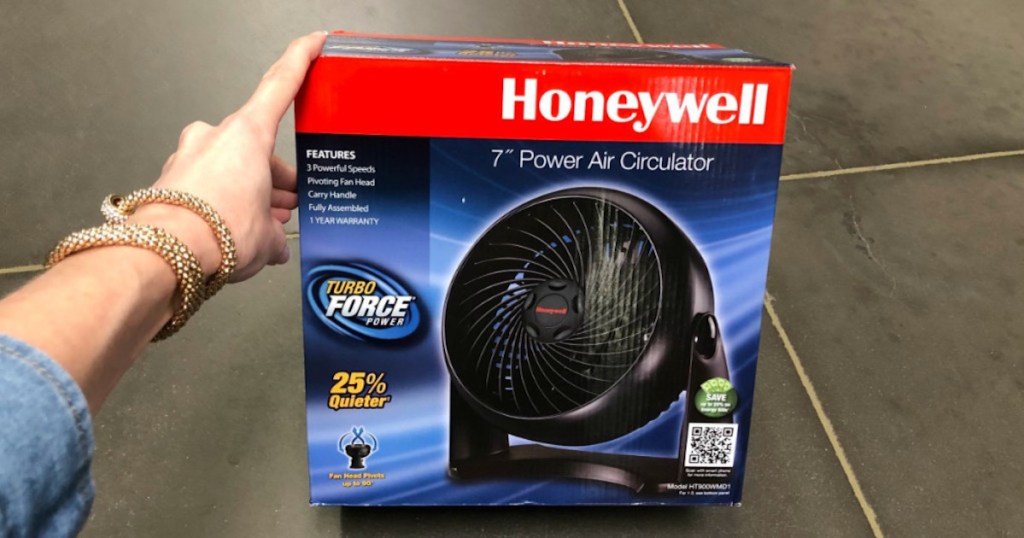 woman hand holding Honeywell Table Air Circulator Fan box