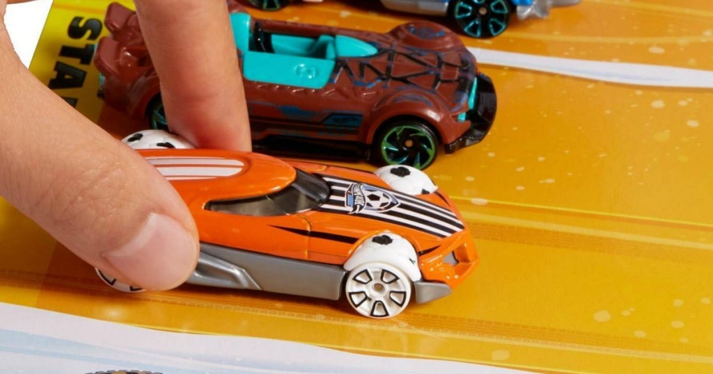 Kid playing with hot wheels car