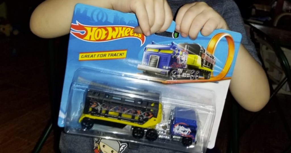 Little boy with Hot Wheels Track Stars Trucks in package