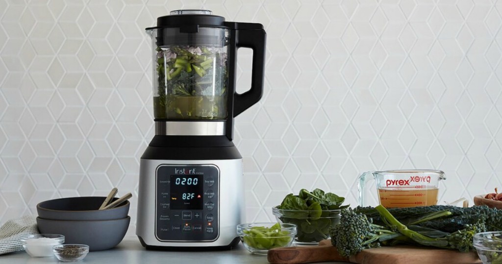 Instant Pot Nova Blender on table with vegetables