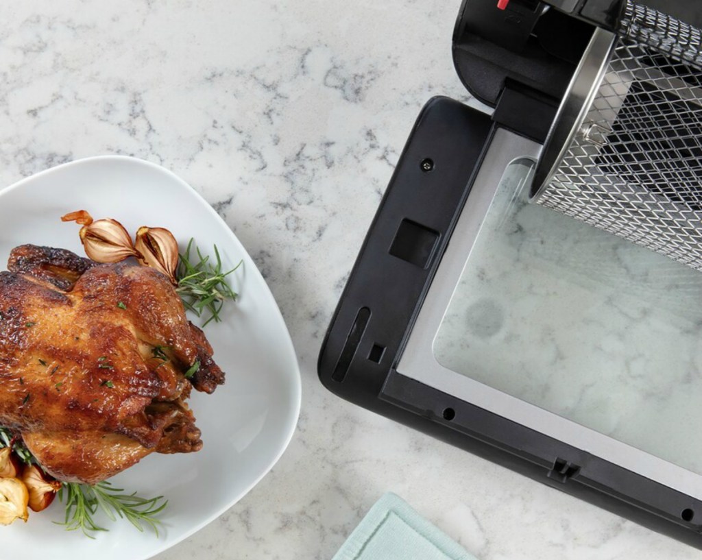 cooked chicken next to air fryer oven