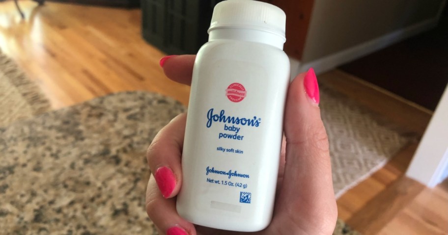 hand holding johnson baby powder, one of the companies to register with if you want to know how to be a product tester