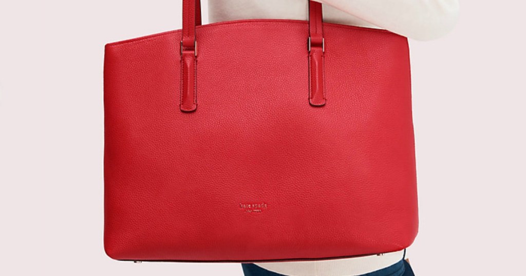 Kate Spade abbot tote in red on woman's shoulder