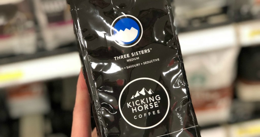 Kicking Horse Coffee whole bean in package in hand in-store