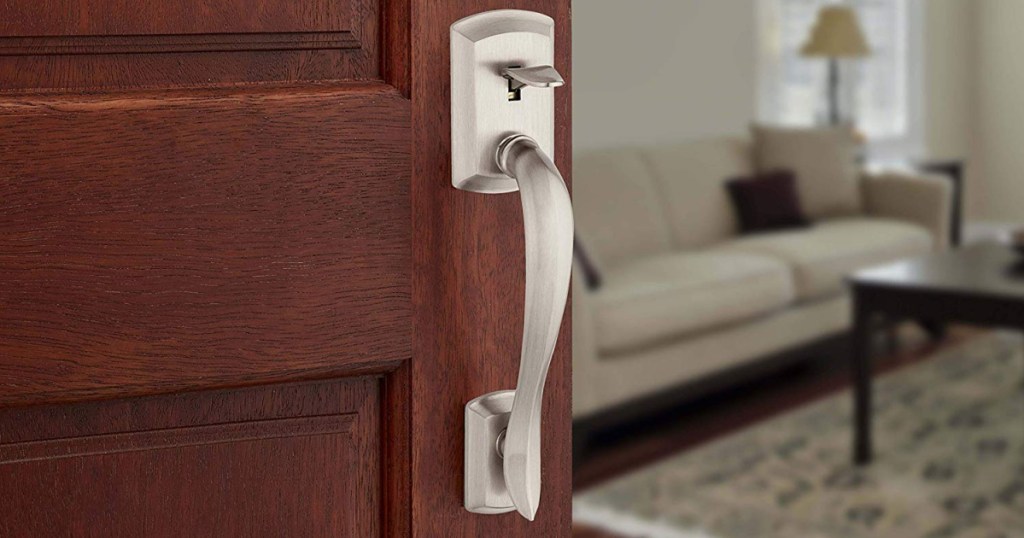 silver door lever on brown door slightly ajar