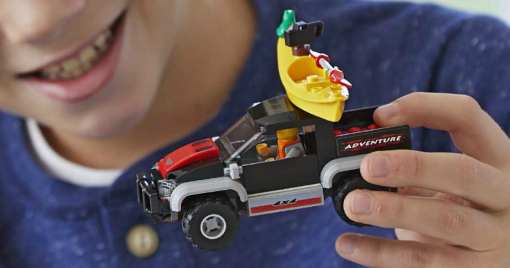 Boy playing with a LEGO vehicle