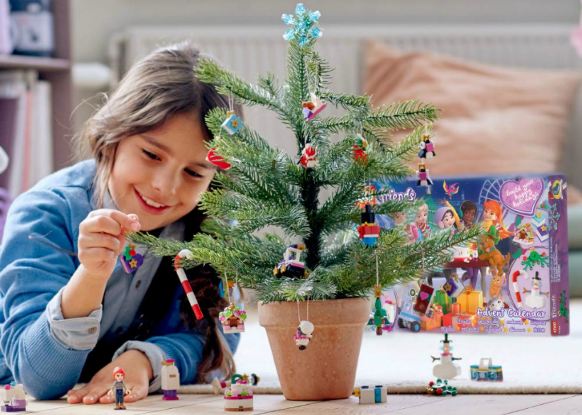 girl playing on the floor with LEGO Friends Advent Calendar set