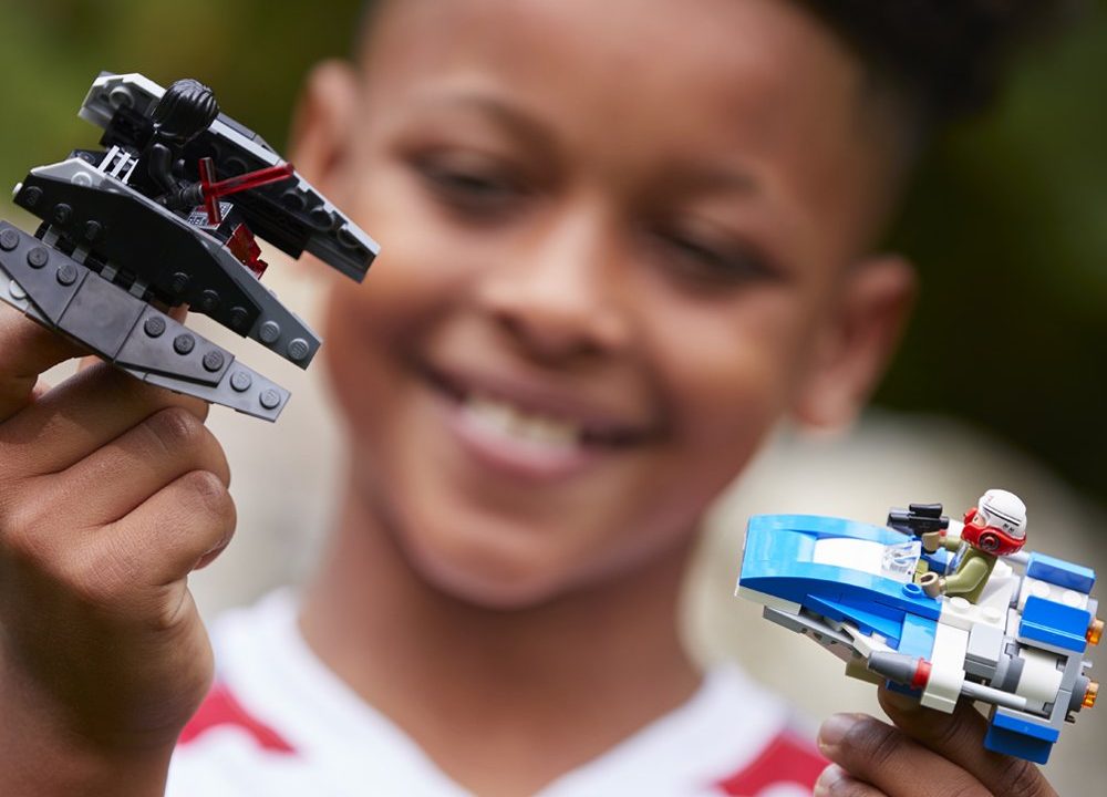 boy playing with LEGO Star Wars- The Last Jedi A-Wing vs. TIE Silencer Microfighters