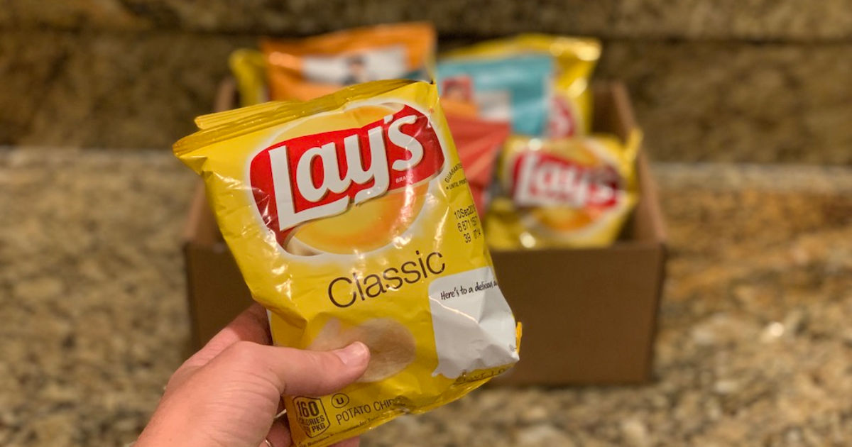Lay's potato chips in hand