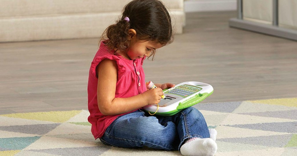 Young girls playing with a Leapfrog education game