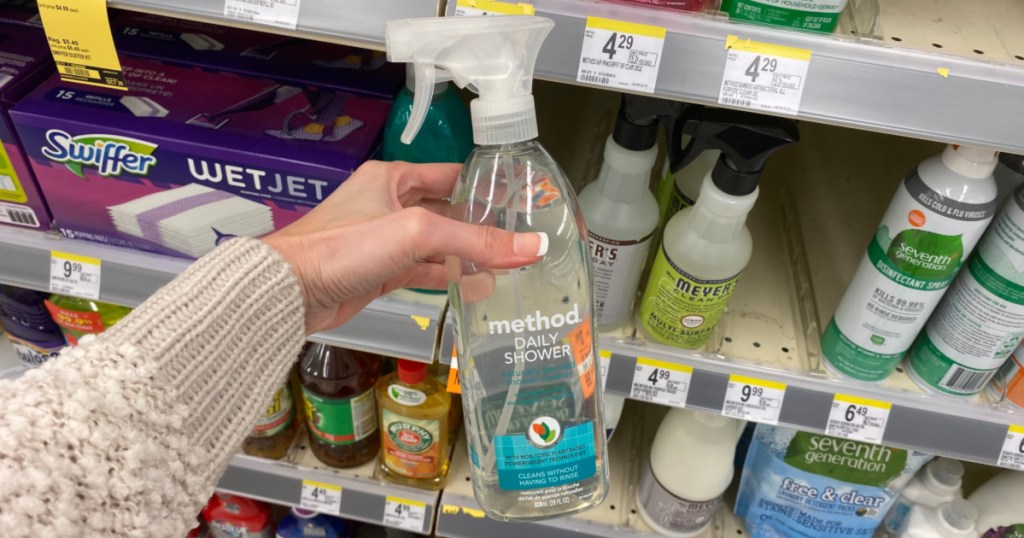 hand holding up bottle of method shower cleaner at walgreens