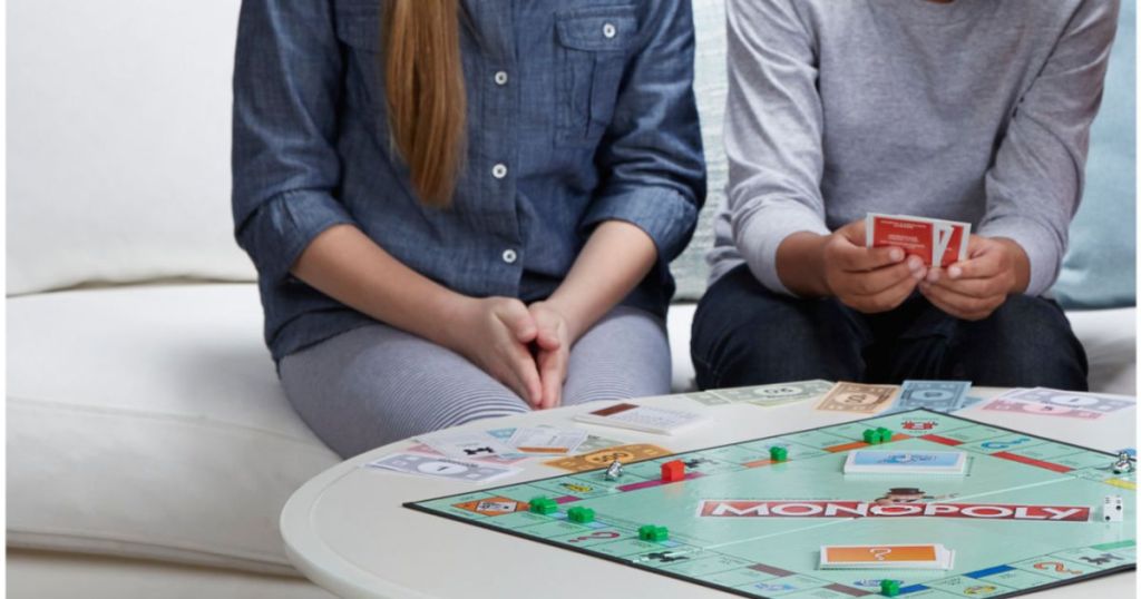 two kids playing monopoly