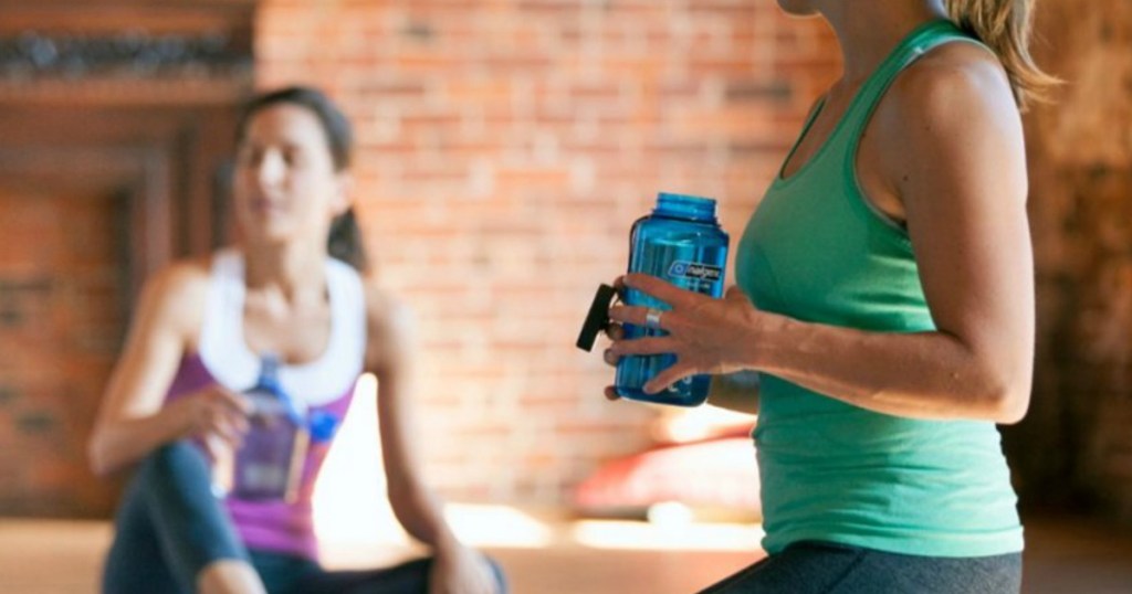 lady working out and holding a Nalgene Water Bottle