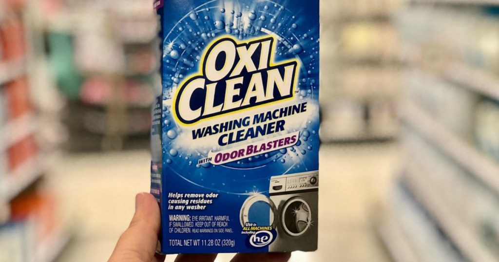 someone holding OxiClean odor blasters at a store