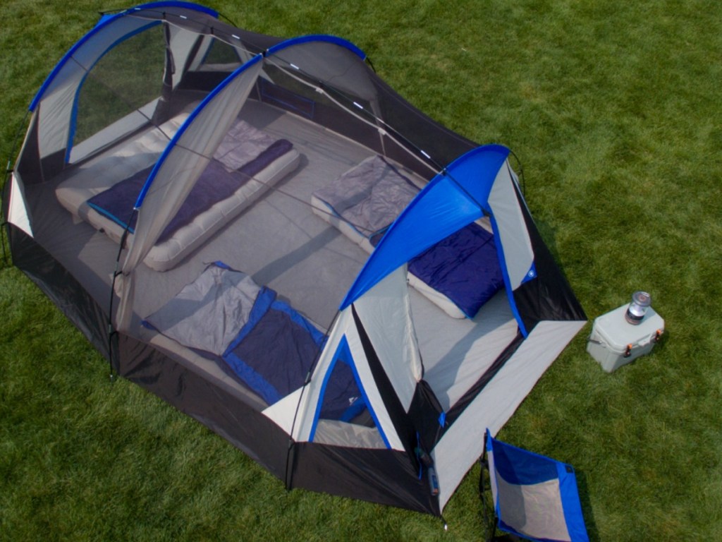 Camping Tent on the grass with a chair and cooler