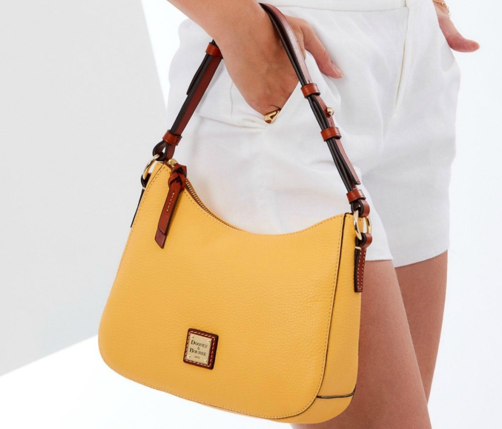 Woman holding a handbag in yellow