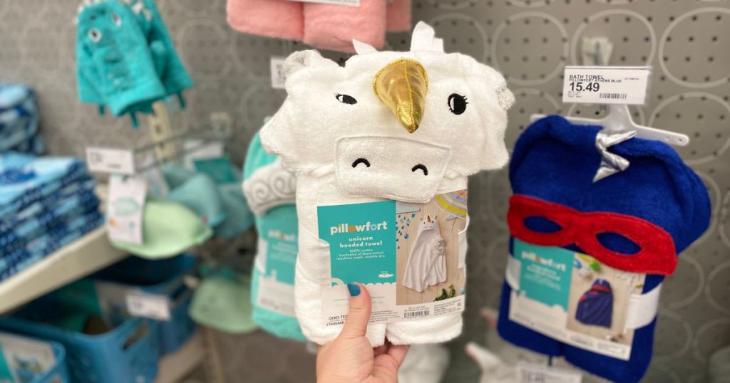 hand holding Pillowfort Unicorn Hooded Bath Towel White in store