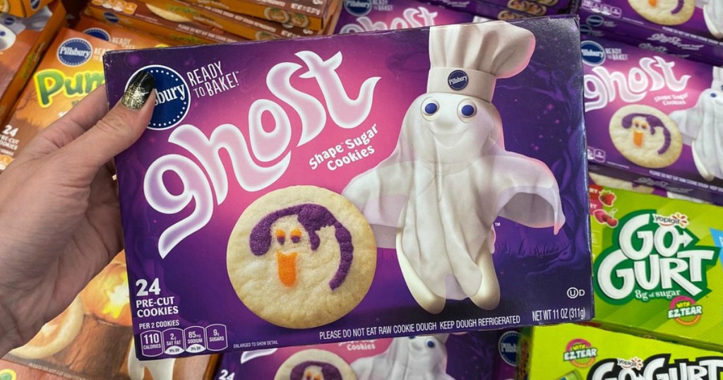woman holding box of Pillsbury ghost shape sugar cookies
