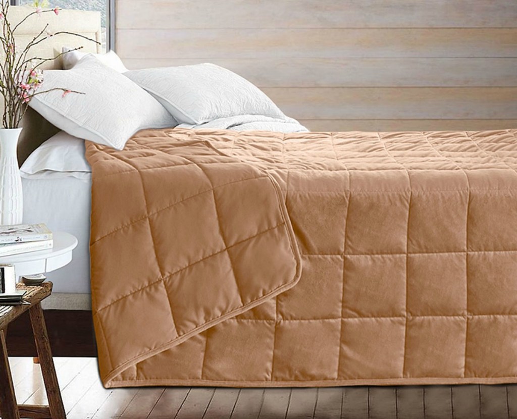 Puredown brand weighted blanket in khaki color on bedspread