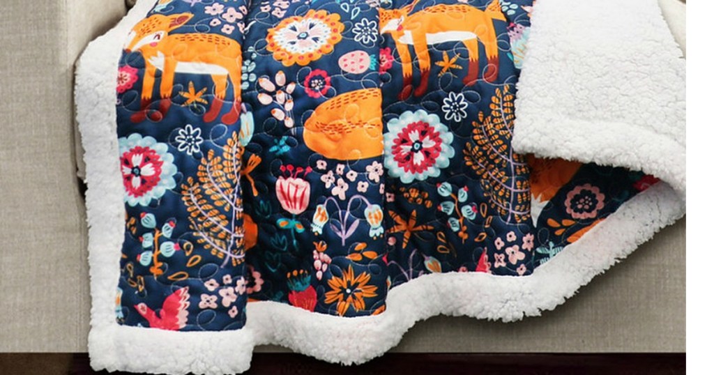 Navy Pixie Fox Sherpa-Lined Quilted Throw on couch